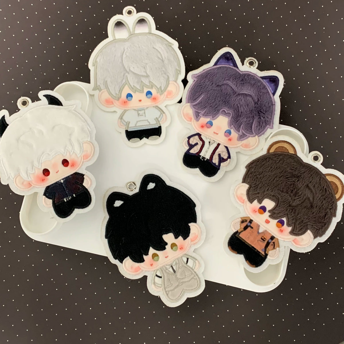 Five 3.94 inch Love and Deepspace character plush charms on a tray
