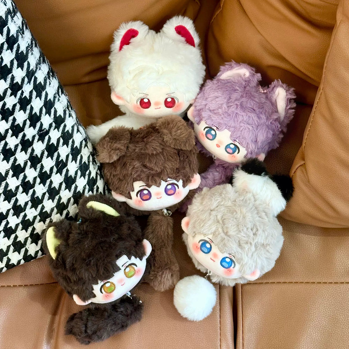 Love and Deepspace tail bun plush dolls five colorways on a sofa