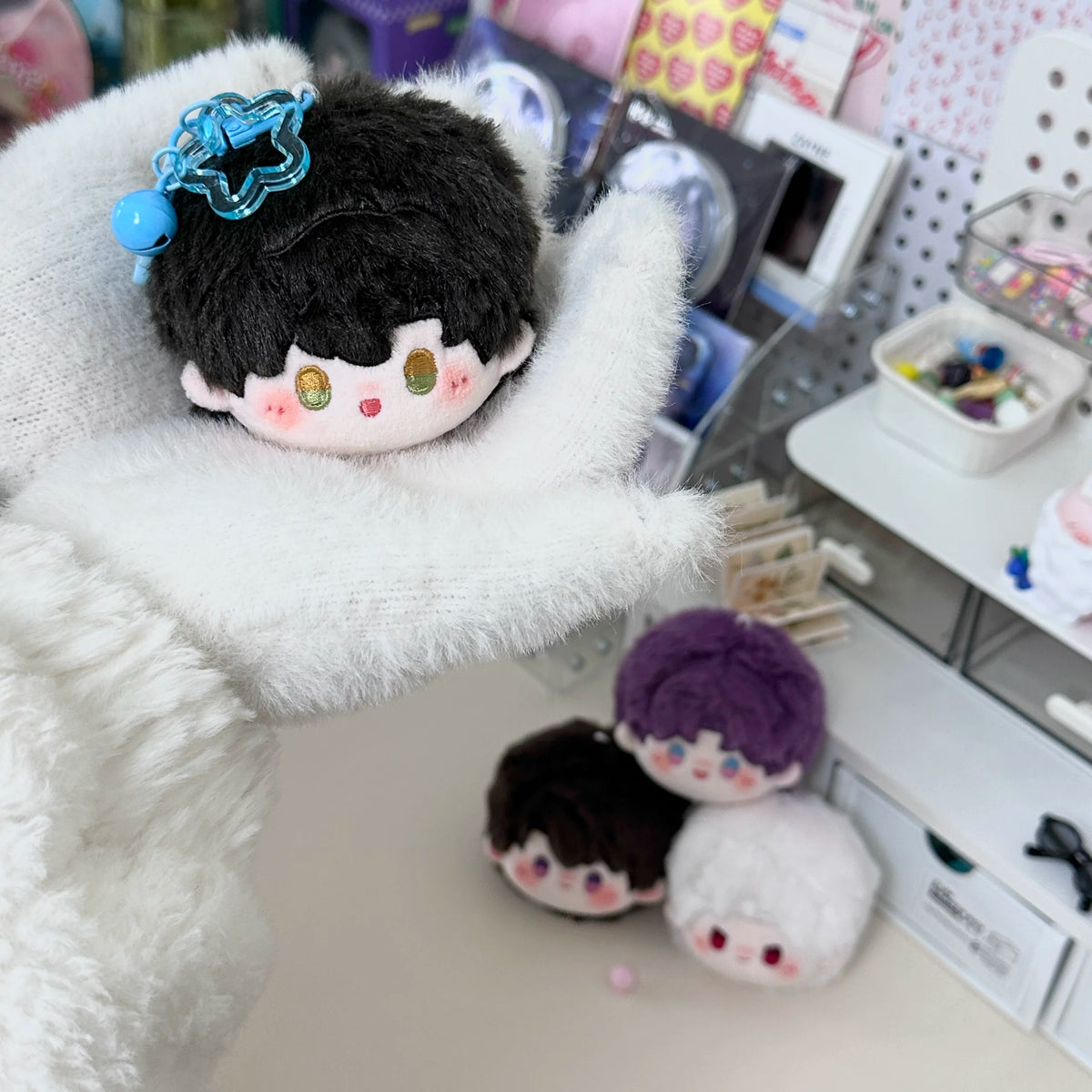 Love and Deepspace round plush doll charms black and purple hair on fluffy blanket