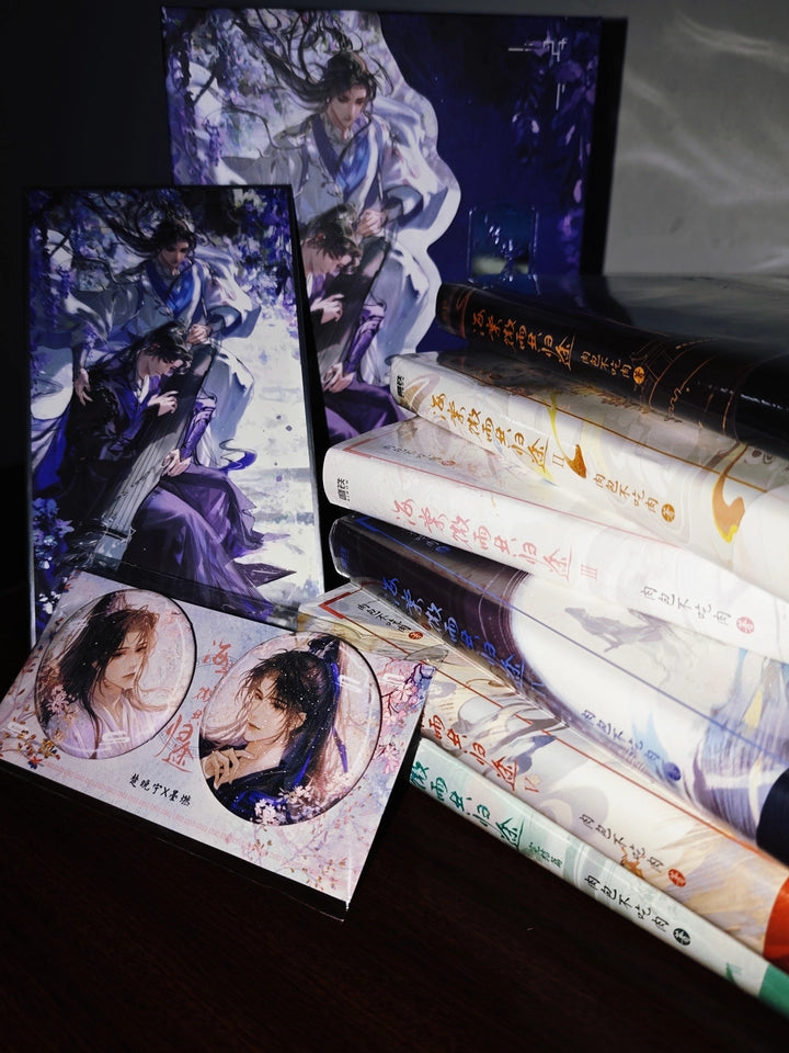 The Husky and His White Cat Shizun novels purple character prints beside stacked novels