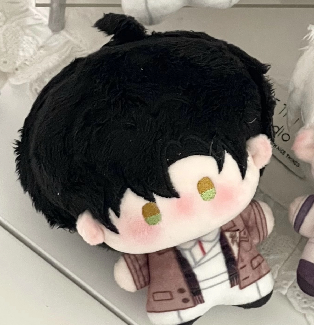 Love and Deepspace Birthday plush charm black hair doll close-up