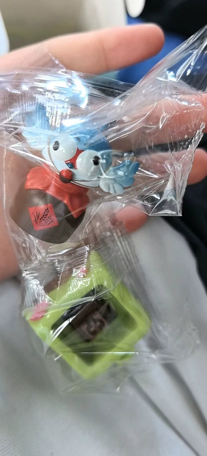 Where Winds Meet mini ceramic keycaps in clear packaging, held in hand