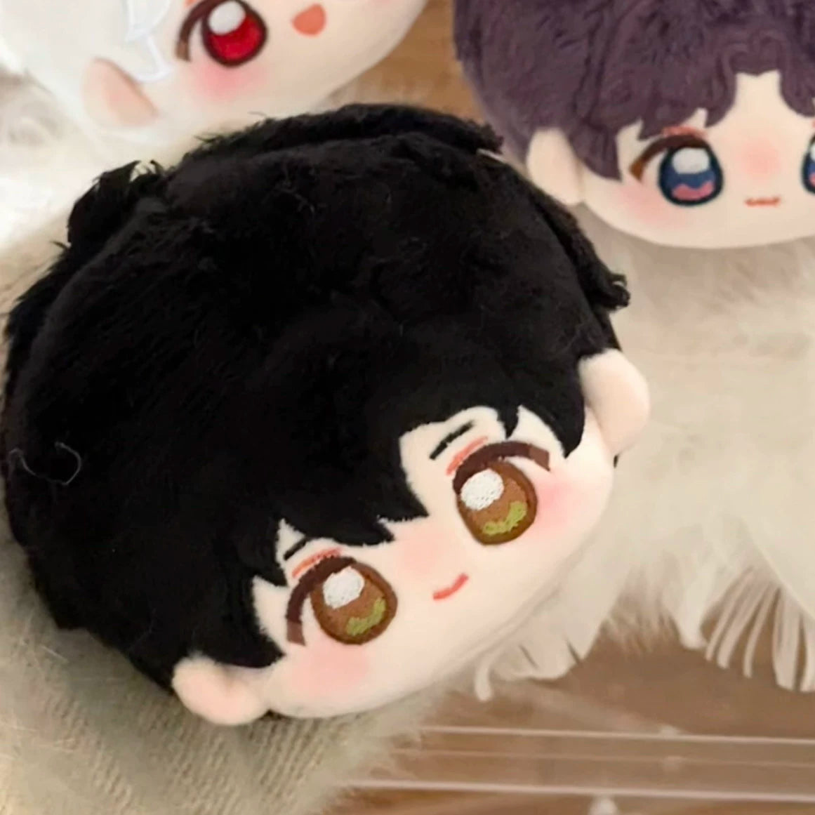 Love and Deepspace round-head plush charm black-haired character close-up