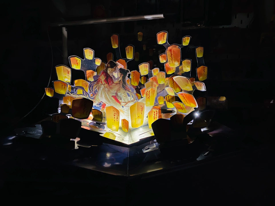 TGCF pop-up book lantern display glowing in darkness