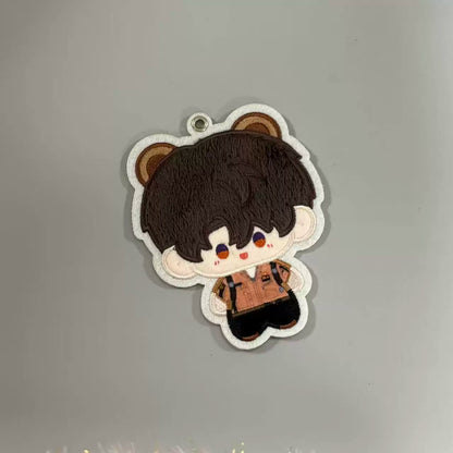 Fan-made Caleb embroidered plush charm with brown bear-ear design