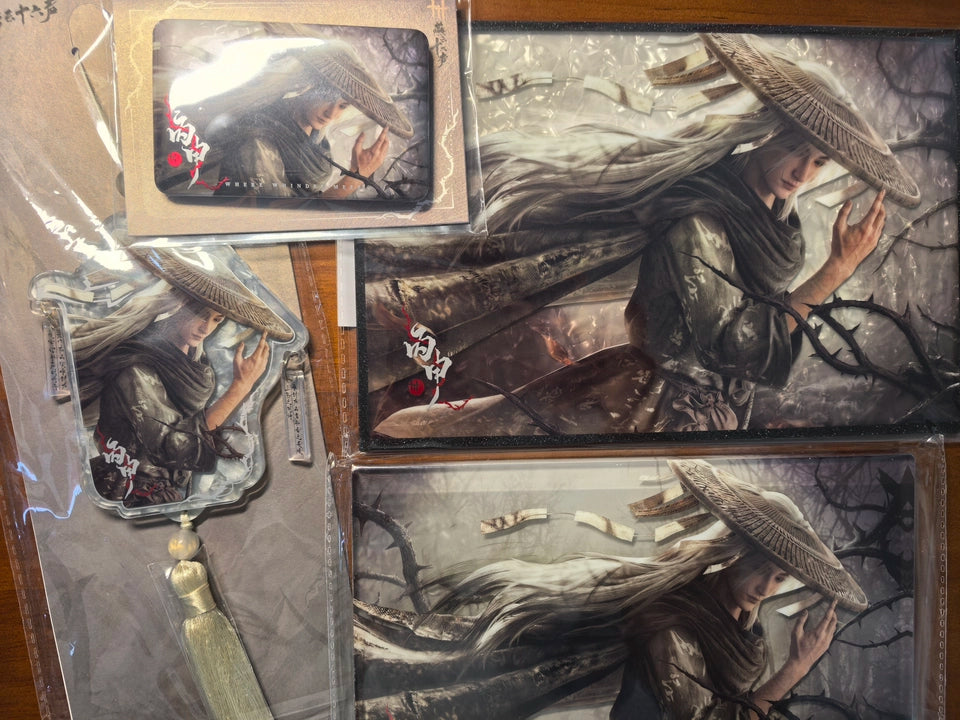 Where Winds Meet character series acrylic charms and art board set laid out on wooden table