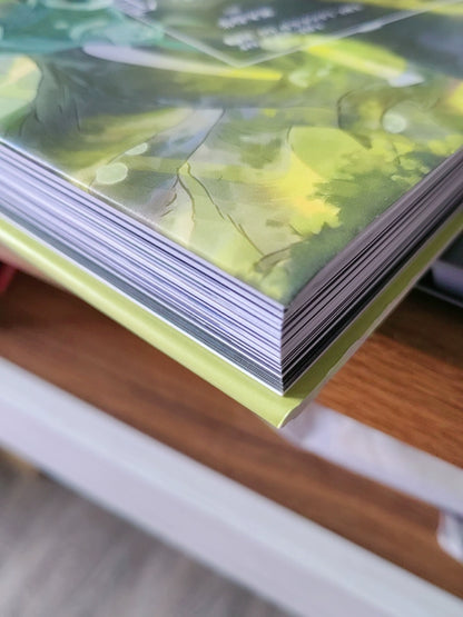 The Legend of Hei movie art setting book page edges on a wooden table