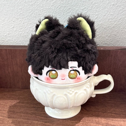 Love and Deepspace tail bun plush doll black hair sitting in a porcelain cup
