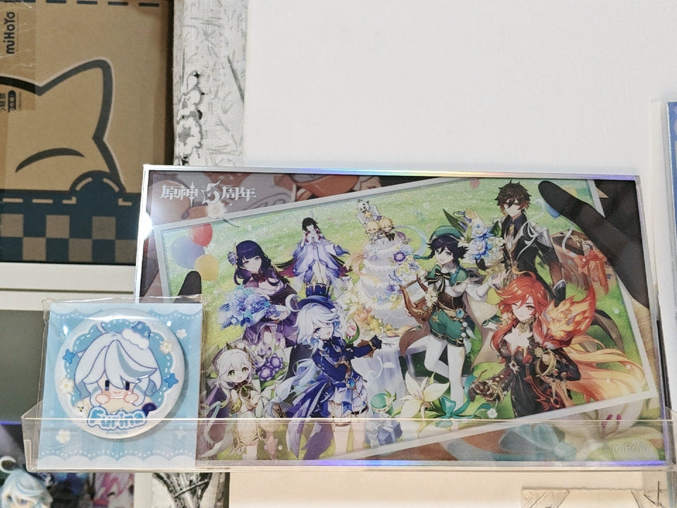 Genshin Impact anniversary acrylic art board displayed with badge and packaging