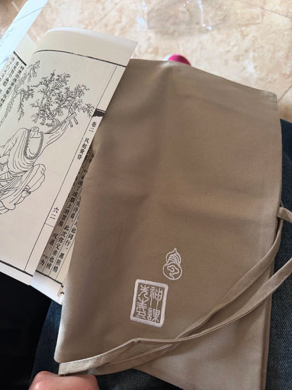 Black Myth Wukong Ying Shen Tu open book partly covered by cloth wrap