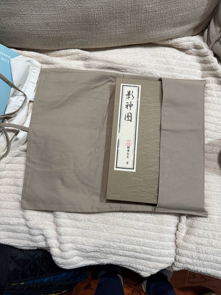 Black Myth Wukong Ying Shen Tu book resting inside unfolded cloth wrap